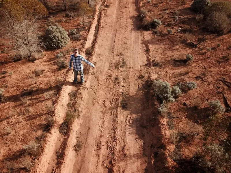 Drone view looking straight down at a researcher on an outback track