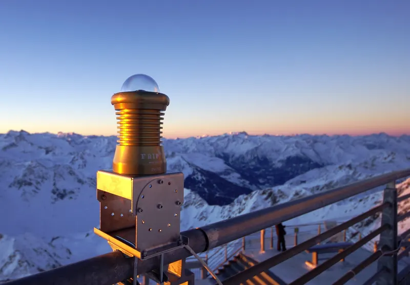 Gold FRIPON all-sky camera on a snowy mountain summit at dusk
